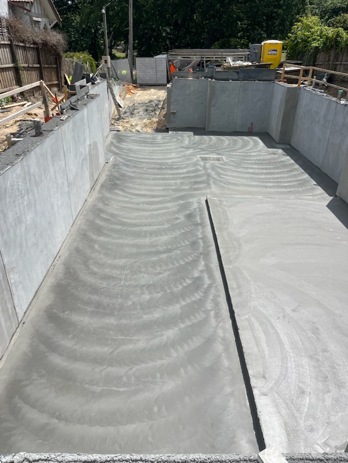 A basement slab running between concrete walls