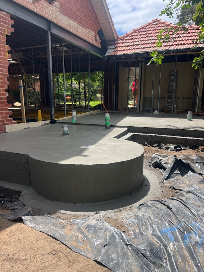 A raised slab with a curved edge at a brick house extension